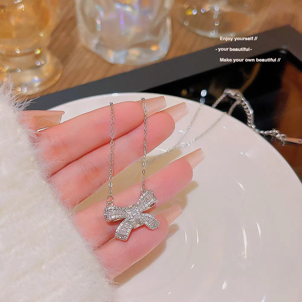 The Bow Necklace, held