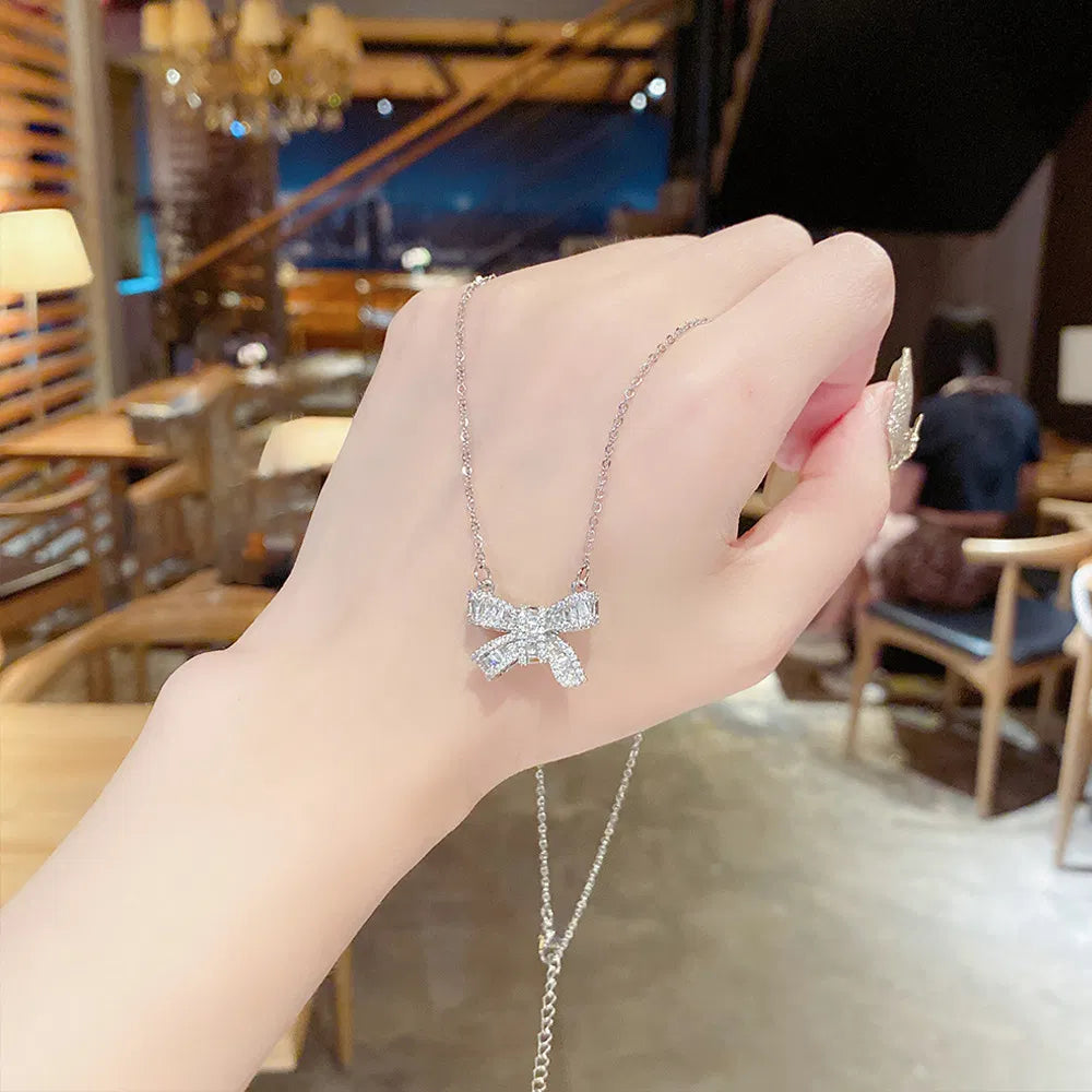 The Bow Necklace, held