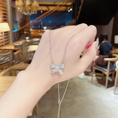 The Bow Necklace, held