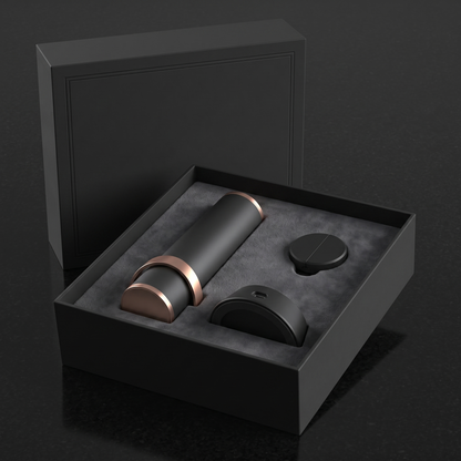 The Column in its suede-lined presentation box with the charging base and foil cutter