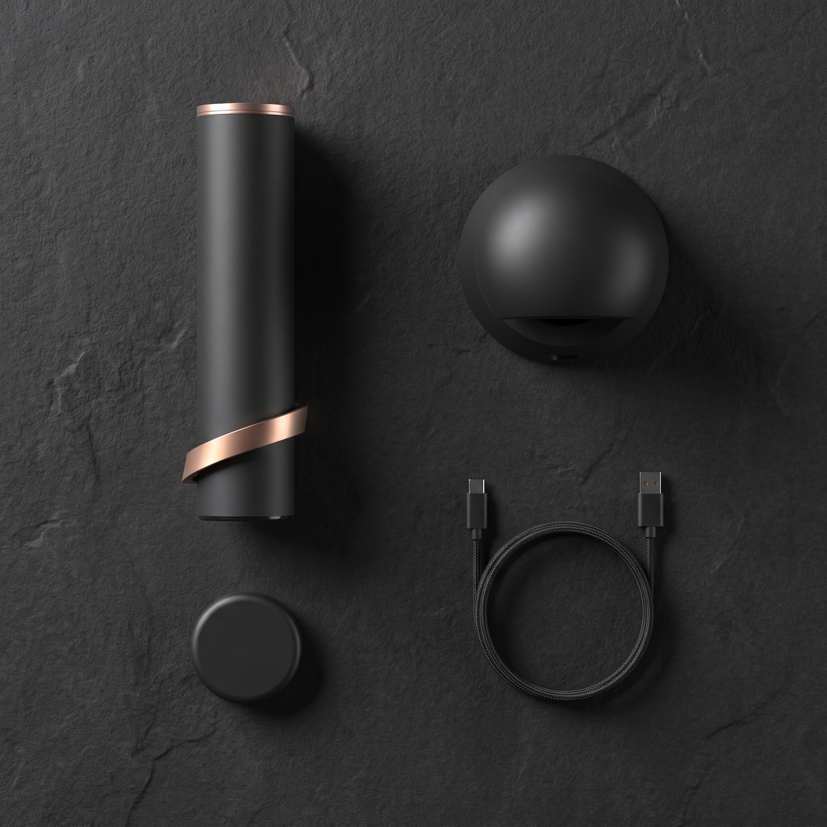 Overhead flat lay of the Column, its charging base, the foil cutter and the USB-C cable