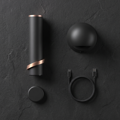 Overhead flat lay of the Column, its charging base, the foil cutter and the USB-C cable