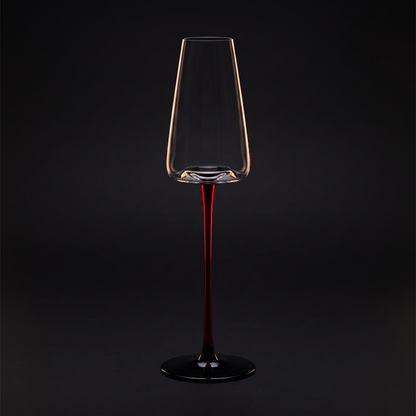 Champagne glass on the scarlet stem, black ground