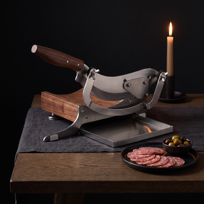 Charcuterie Guillotine on a candlelit table with salami and olives