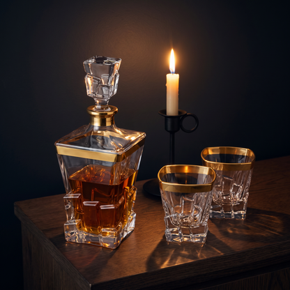 Gilt Crystal Decanter Set by candlelight on a dark oak sideboard