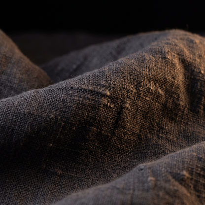 The weave, close — stone-washed charcoal flax linen