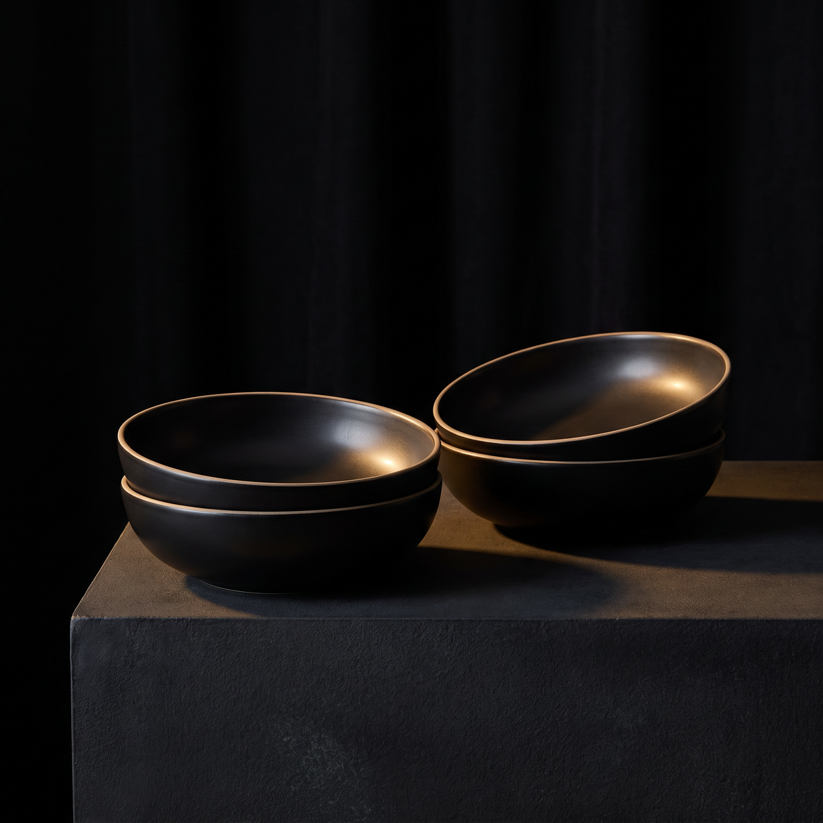 Four noir glaze coupes, stacked in pairs