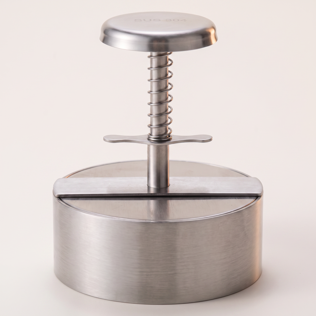 Piston Burger Press in 304 stainless, on a light ground